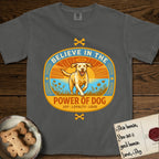 Believe in the Power of Dog Yellow Lab T-Shirt flat lay in Pepper, featuring a vintage oval badge with a haloed Yellow Lab running through a field of wildflowers and the words Joy, Loyalty, Love.