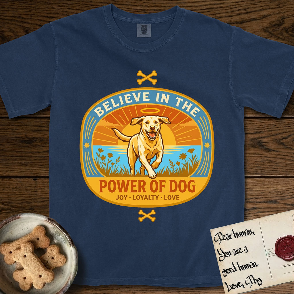 Believe in the Power of Dog Yellow Lab T-Shirt flat lay in True Navy, featuring a vintage oval badge with a haloed Yellow Lab running through a field of wildflowers and the words Joy, Loyalty, Love.