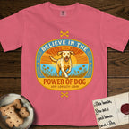 Believe in the Power of Dog Yellow Lab T-Shirt flat lay in Watermelon, featuring a vintage oval badge with a haloed Yellow Lab running through a field of wildflowers and the words Joy, Loyalty, Love.