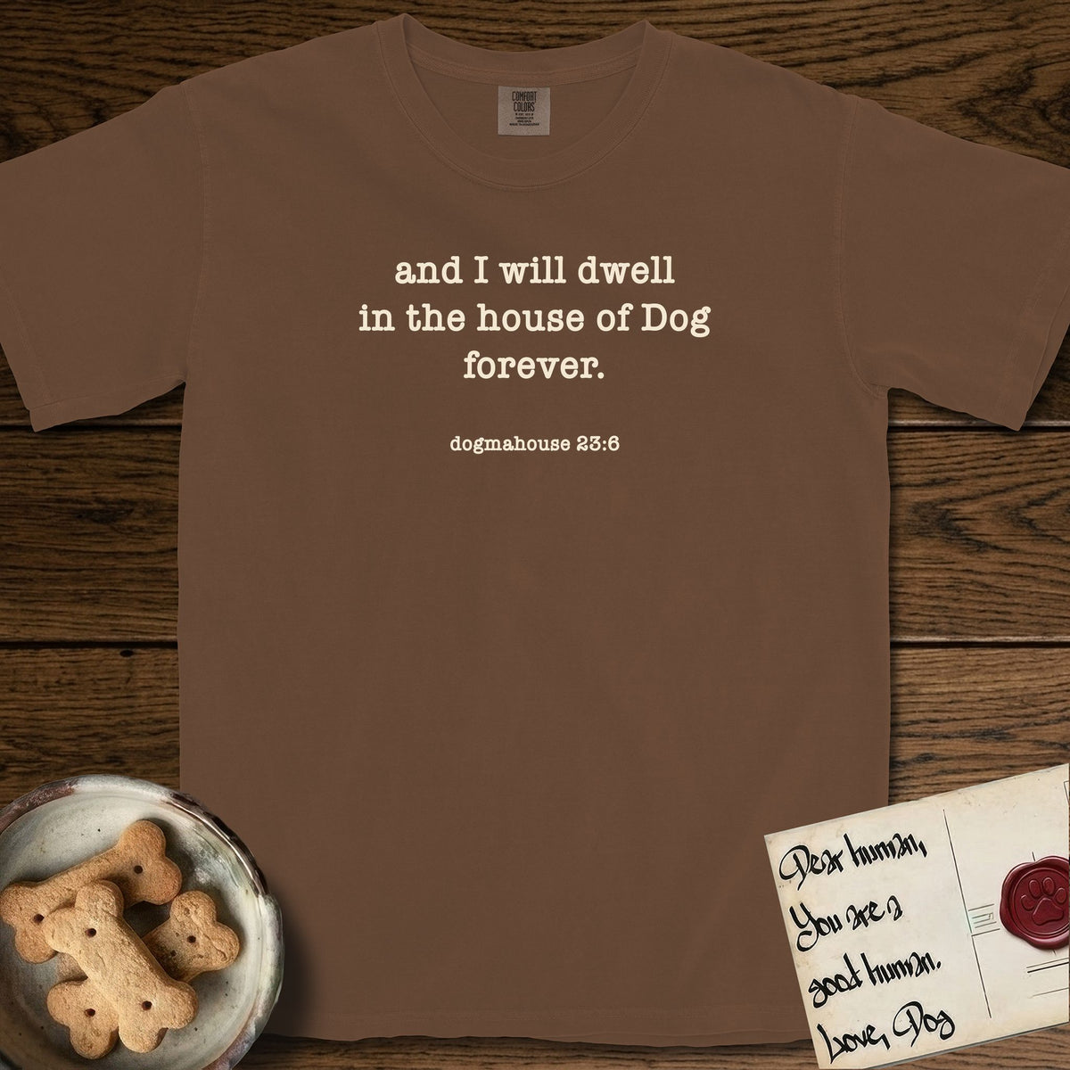 And I Will Dwell T-Shirt flat lay in Espresso, featuring Small centered typewriter-type text reading and I will dwell in the house of Dog forever, with the citation dogmahouse 23:6 beneath it.