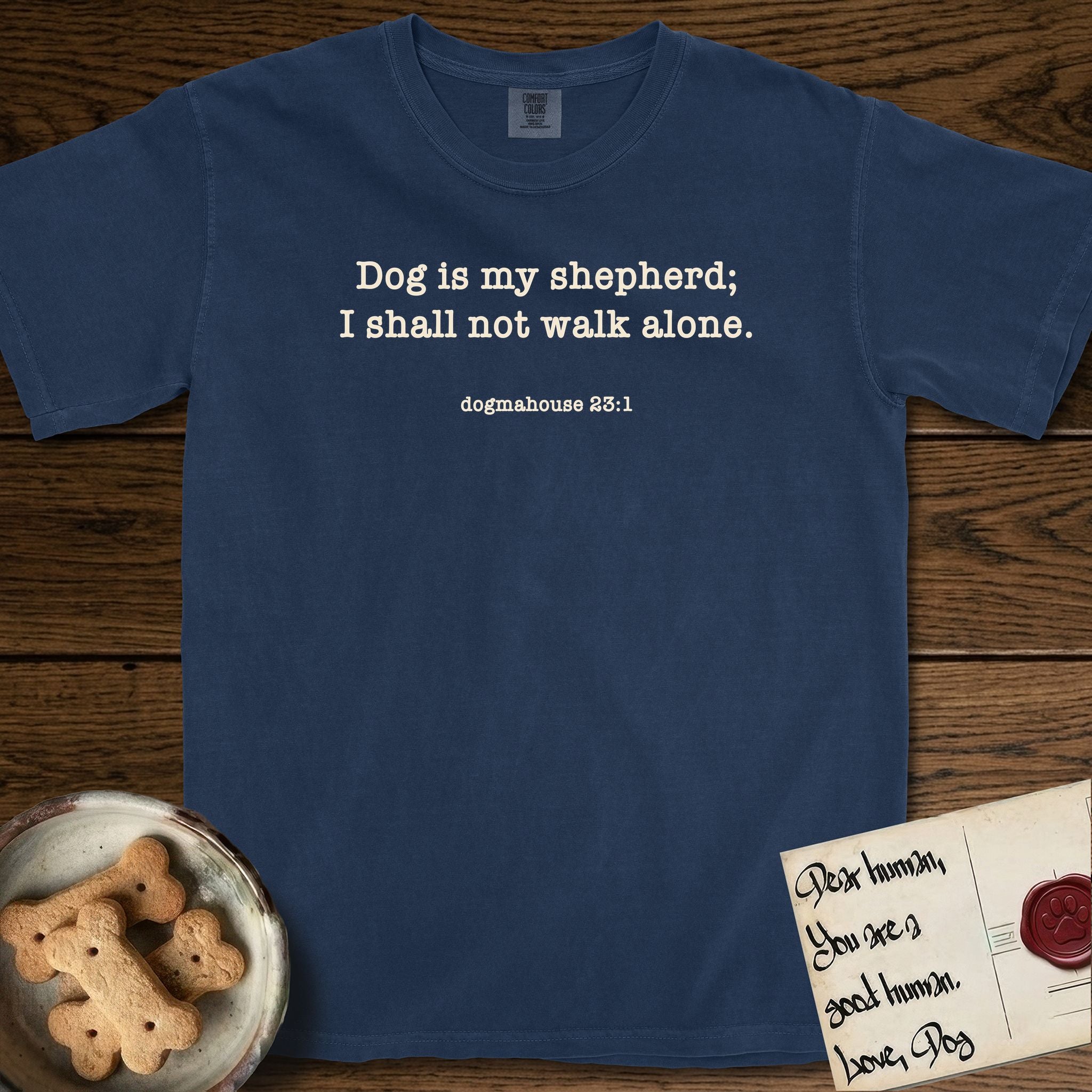 Dog is My Shepherd T-Shirt flat lay in True Navy, featuring Small centered typewriter-type text reading Dog is my shepherd; I shall not walk alone, with the citation dogmahouse 23:1 beneath it.