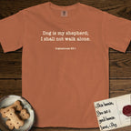 Dog is My Shepherd T-Shirt flat lay in Yam, featuring Small centered typewriter-type text reading Dog is my shepherd; I shall not walk alone, with the citation dogmahouse 23:1 beneath it.