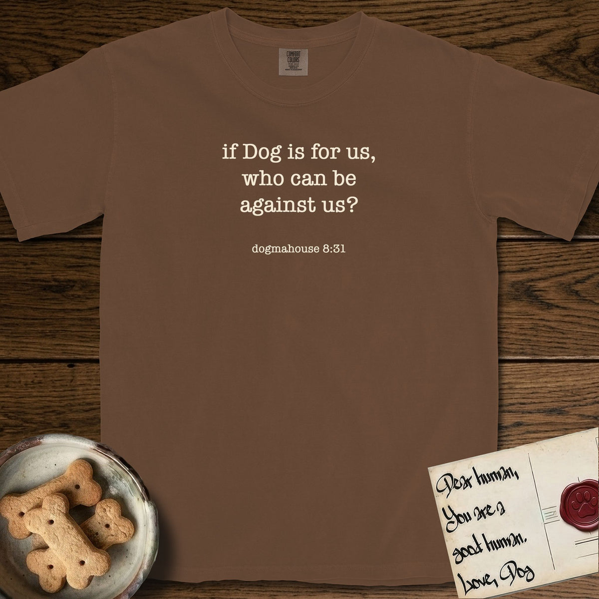 If Dog is For Us T-Shirt flat lay in Espresso, featuring Small centered typewriter-type text reading if Dog is for us, who can be against us?, with the citation dogmahouse 8:31 beneath it.