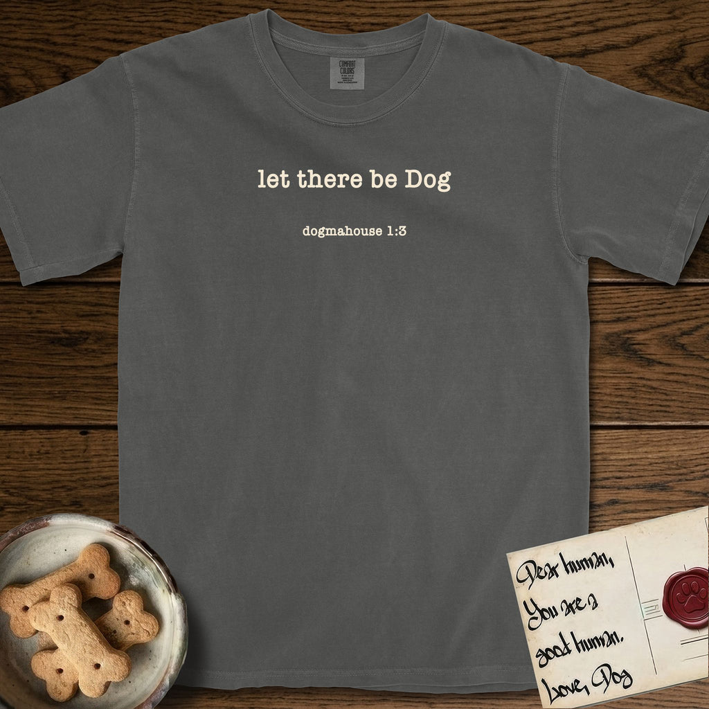 Let There Be Dog T-Shirt flat lay in Pepper, featuring Small centered typewriter-type text reading let there be Dog, with the citation dogmahouse 1:3 beneath it.