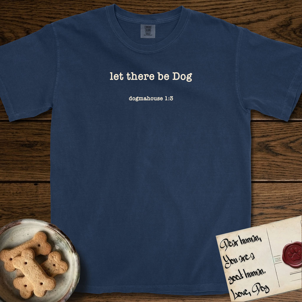 Let There Be Dog T-Shirt flat lay in True Navy, featuring Small centered typewriter-type text reading let there be Dog, with the citation dogmahouse 1:3 beneath it.