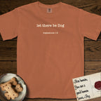 Let There Be Dog T-Shirt flat lay in Yam, featuring Small centered typewriter-type text reading let there be Dog, with the citation dogmahouse 1:3 beneath it.