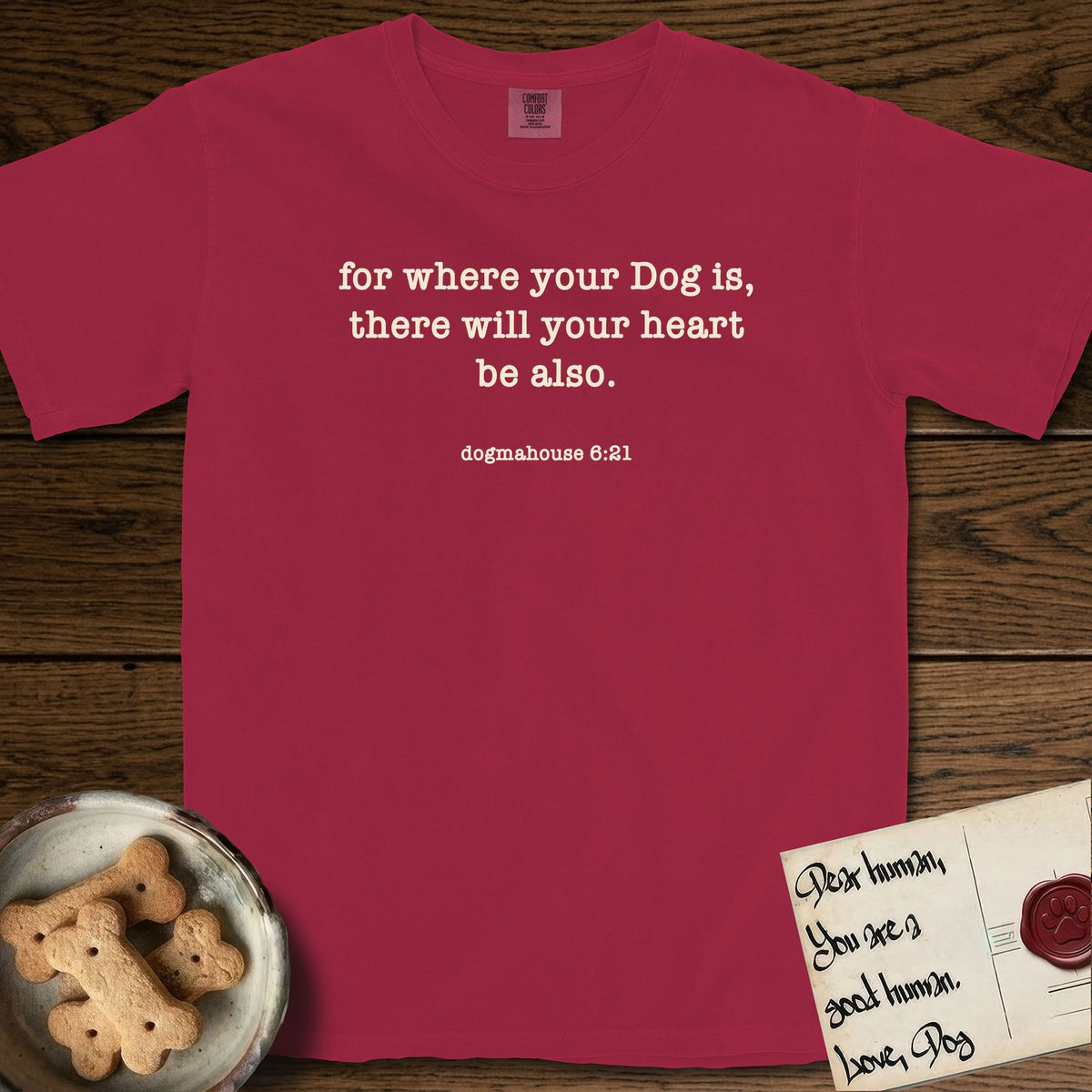 Where Your Dog Is T-Shirt flat lay in Chili, featuring Small centered typewriter-type text reading for where your Dog is, there will your heart be also, with the citation dogmahouse 6:21 beneath it.