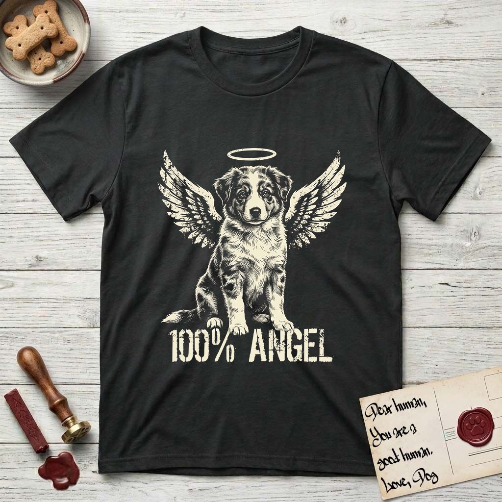 Australian Shepherd T-Shirt flat lay in Black, featuring Distressed cream one-color screen-print of a blue merle Australian Shepherd puppy as an angel, wings raised and a halo above, with 100% ANGEL lettering across the bottom.