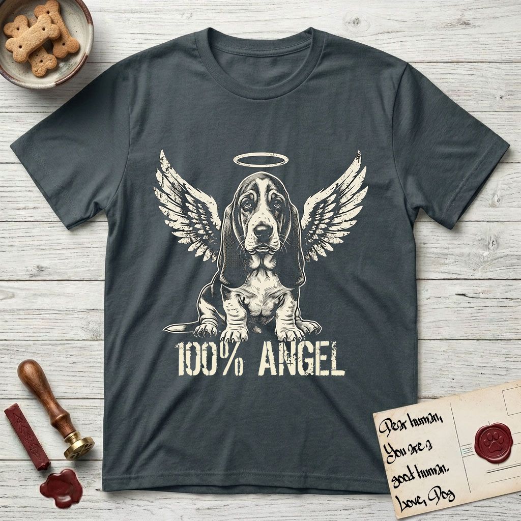 Basset Hound T-Shirt flat lay in Dark Heather Grey, featuring Distressed cream one-color screen-print of a Basset Hound puppy as an angel, long ears draping forward, wings spread and a halo above, with 100% ANGEL lettering across the bottom.