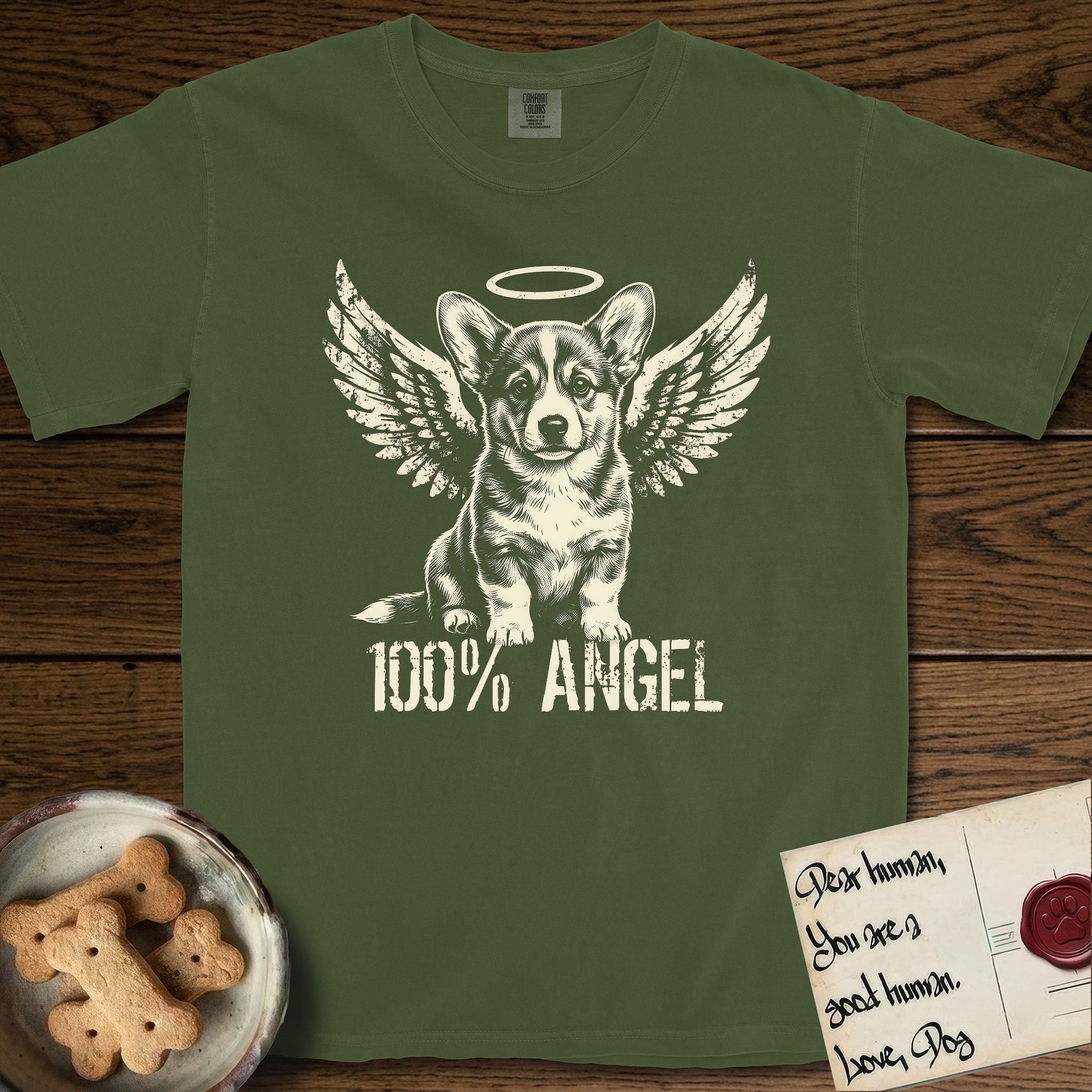 Corgi T-Shirt flat lay in Hemp, featuring Distressed cream one-color screen-print of a Pembroke Welsh Corgi puppy as an angel, big erect ears and short legs, wings spread and a halo above, with 100% ANGEL lettering across the bottom.