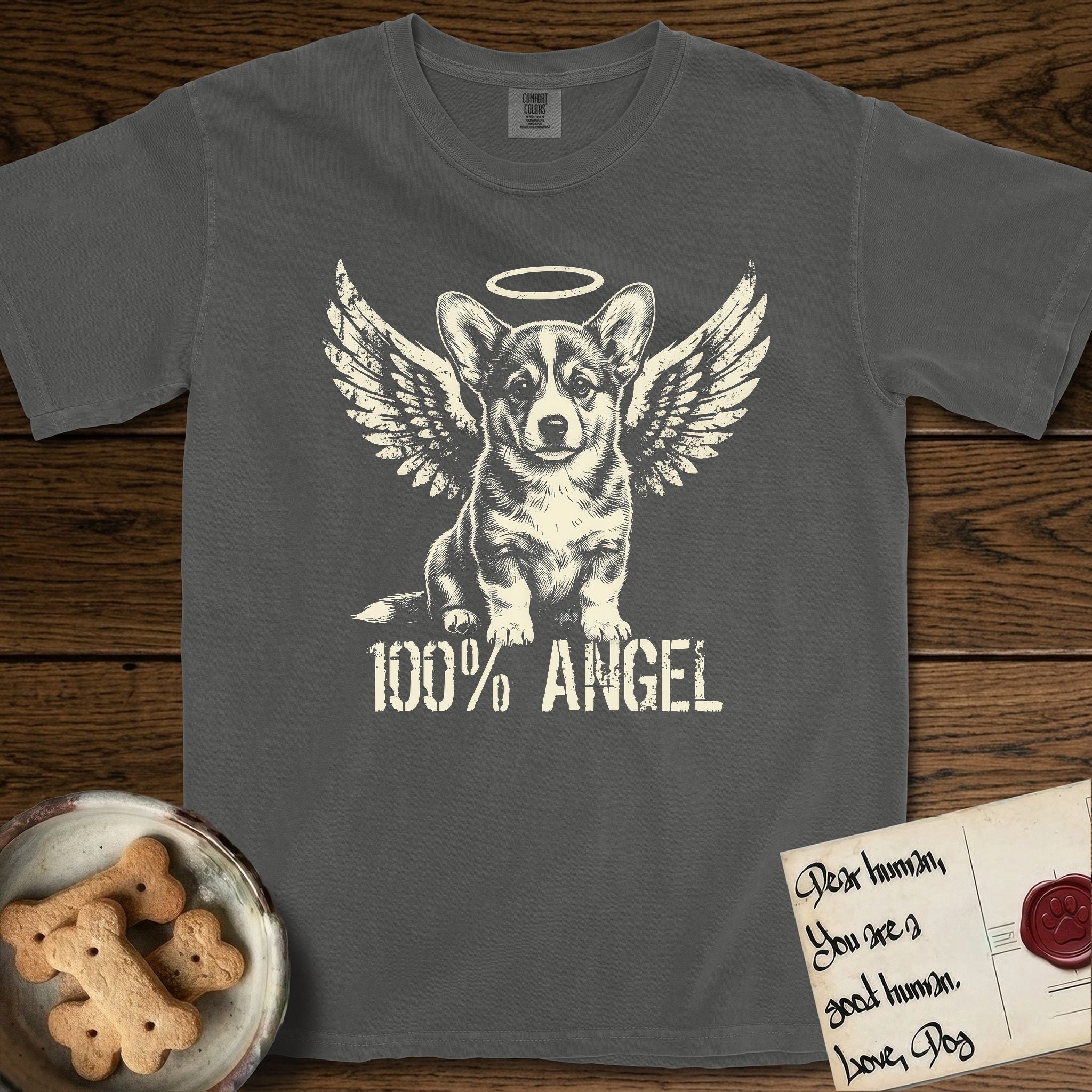 Corgi T-Shirt flat lay in Pepper, featuring Distressed cream one-color screen-print of a Pembroke Welsh Corgi puppy as an angel, big erect ears and short legs, wings spread and a halo above, with 100% ANGEL lettering across the bottom.