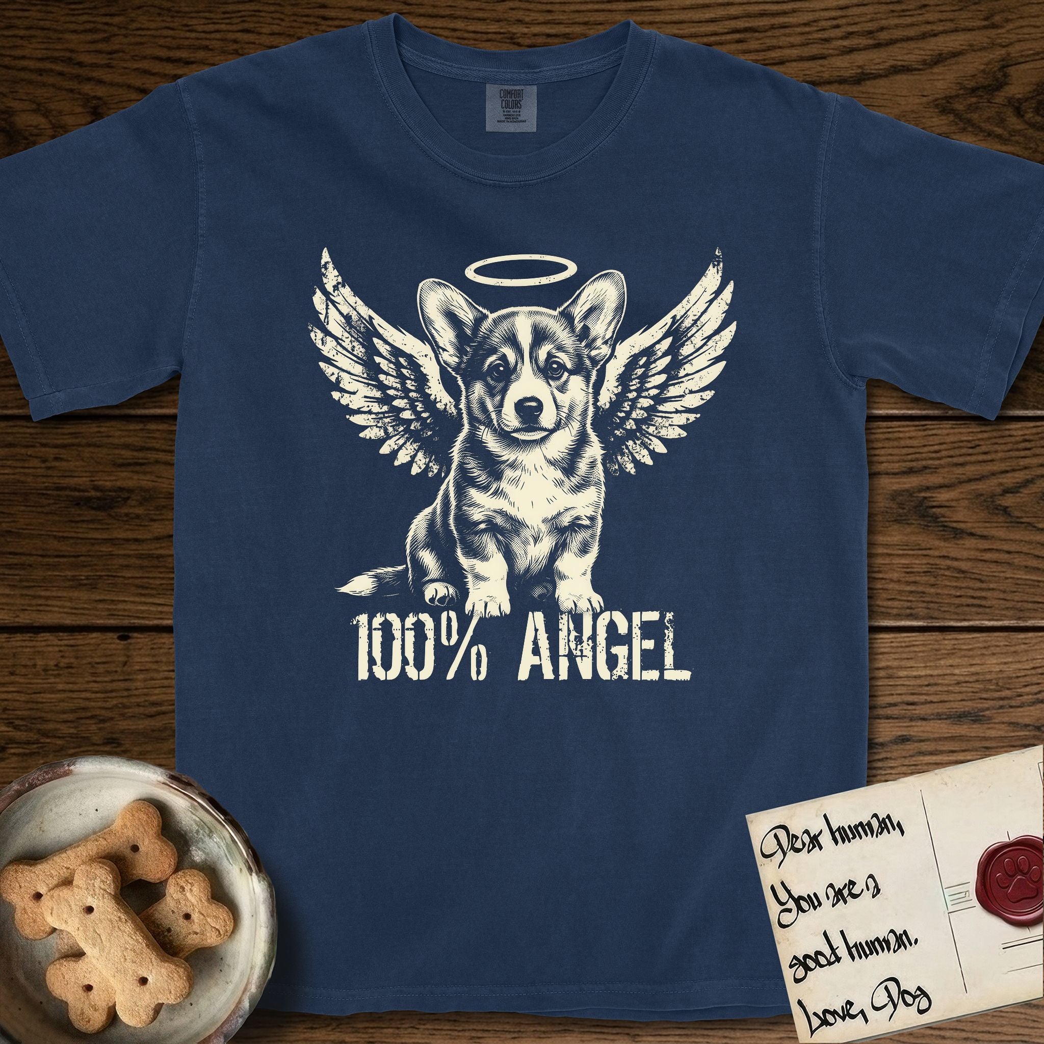 Corgi T-Shirt flat lay in True Navy, featuring Distressed cream one-color screen-print of a Pembroke Welsh Corgi puppy as an angel, big erect ears and short legs, wings spread and a halo above, with 100% ANGEL lettering across the bottom.