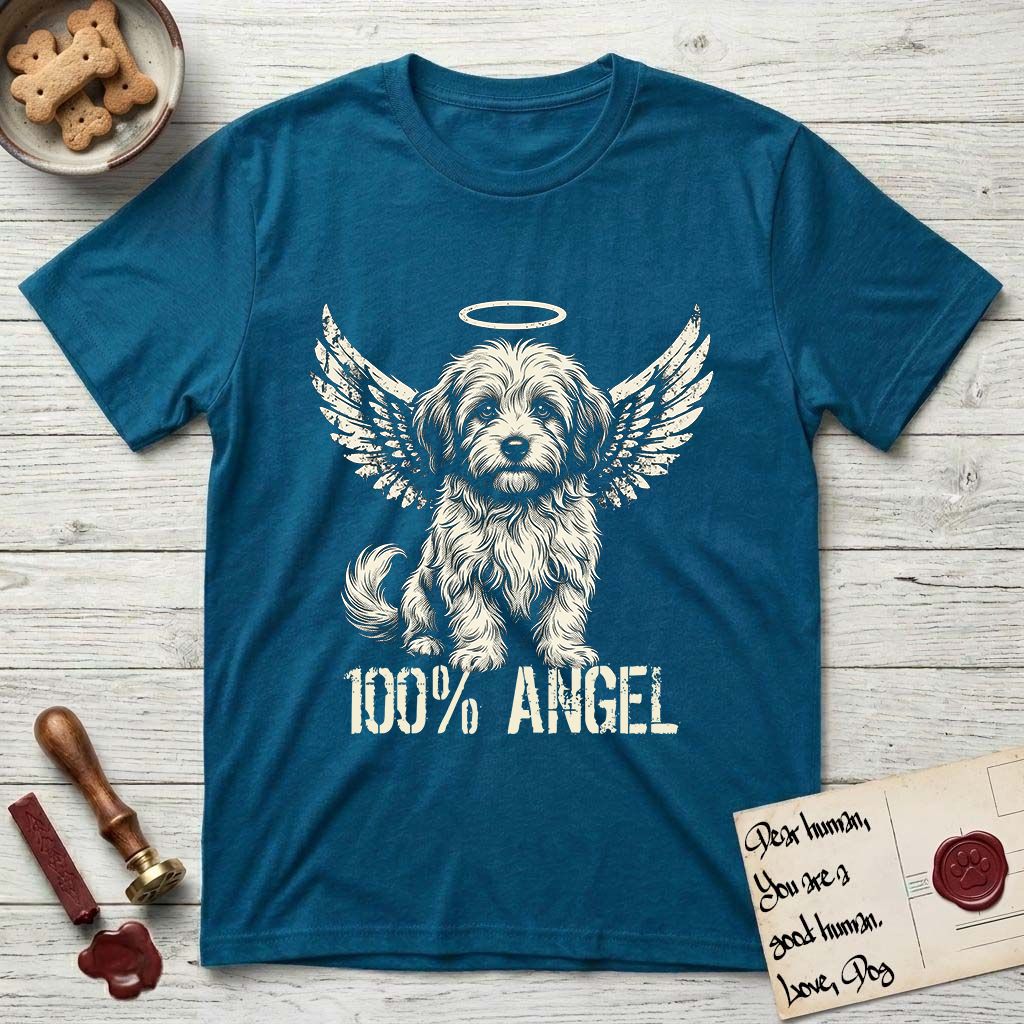 Coton de Tulear T-Shirt flat lay in Antique Sapphire, featuring Distressed cream one-color screen-print of a fluffy white Coton de Tulear puppy as an angel, plumed tail curled beside him, wings spread and a halo above, with 100% ANGEL lettering across the bottom.