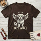 Coton de Tulear T-Shirt flat lay in Dark Chocolate, featuring Distressed cream one-color screen-print of a fluffy white Coton de Tulear puppy as an angel, plumed tail curled beside him, wings spread and a halo above, with 100% ANGEL lettering across the bottom.