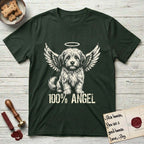 Coton de Tulear T-Shirt flat lay in Forest Green, featuring Distressed cream one-color screen-print of a fluffy white Coton de Tulear puppy as an angel, plumed tail curled beside him, wings spread and a halo above, with 100% ANGEL lettering across the bottom.