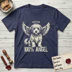 Coton de Tulear T-Shirt flat lay in Navy, featuring Distressed cream one-color screen-print of a fluffy white Coton de Tulear puppy as an angel, plumed tail curled beside him, wings spread and a halo above, with 100% ANGEL lettering across the bottom.
