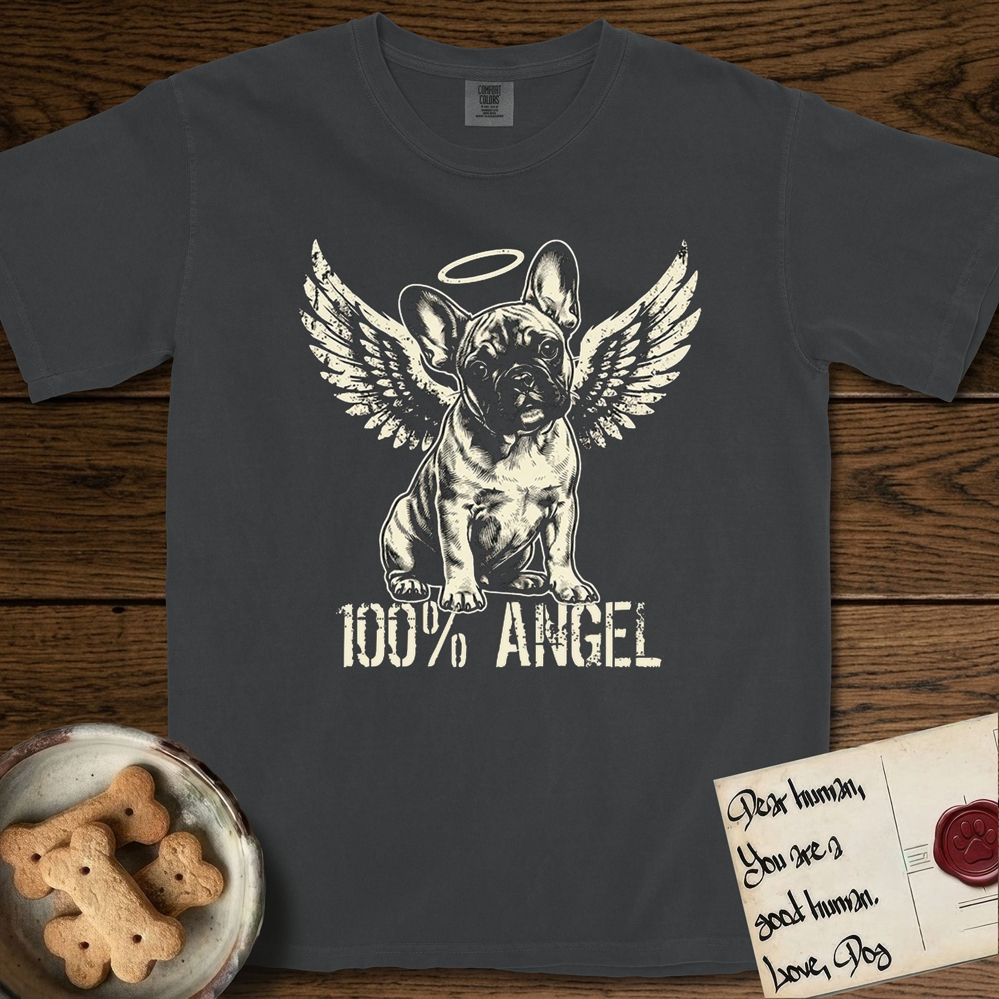 French Bulldog T-Shirt flat lay in Graphite, featuring Distressed cream one-color screen-print of a French Bulldog puppy as an angel, head cocked to one side, wings spread and a halo above, with 100% ANGEL lettering across the bottom.