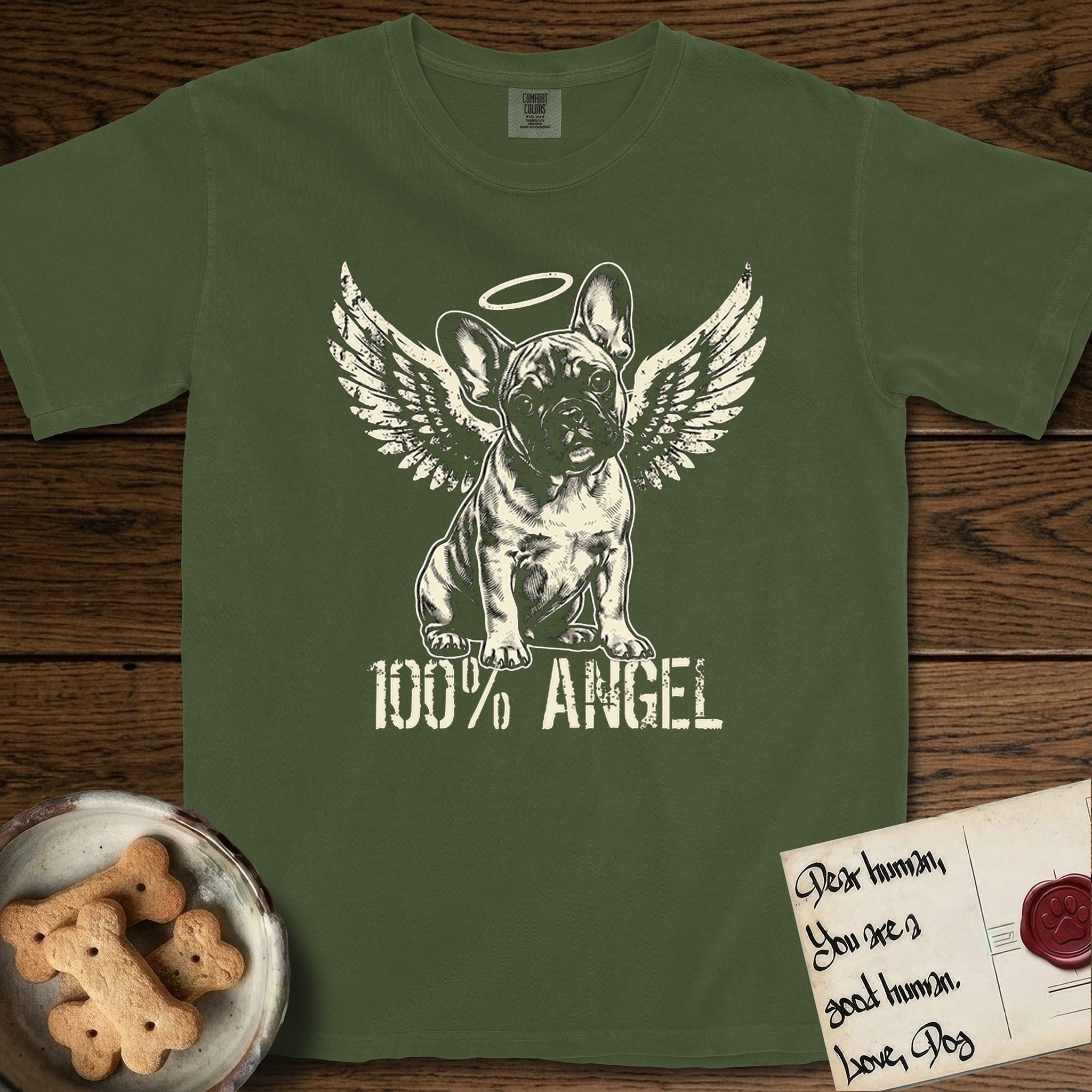 French Bulldog T-Shirt flat lay in Hemp, featuring Distressed cream one-color screen-print of a French Bulldog puppy as an angel, head cocked to one side, wings spread and a halo above, with 100% ANGEL lettering across the bottom.