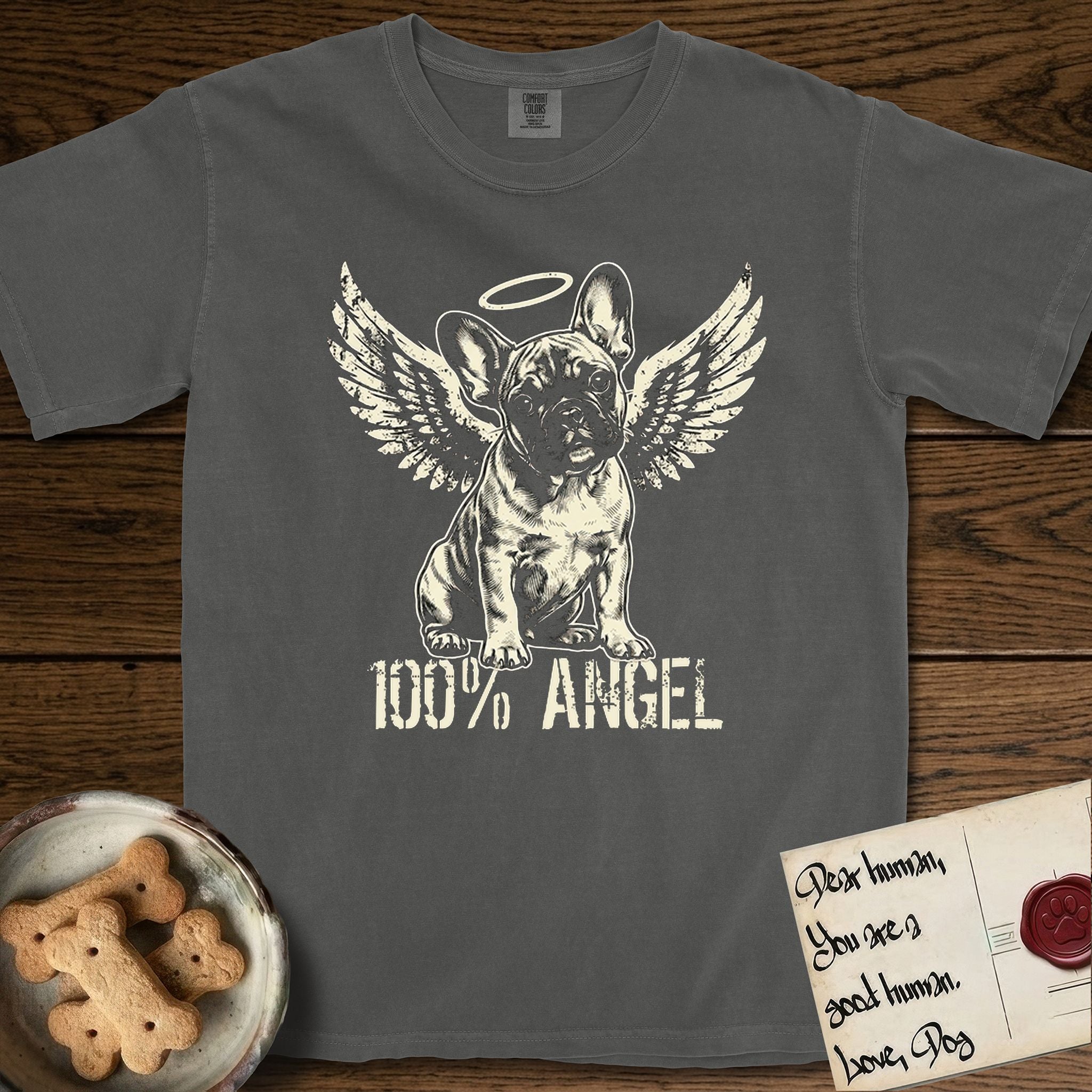 French Bulldog T-Shirt flat lay in Pepper, featuring Distressed cream one-color screen-print of a French Bulldog puppy as an angel, head cocked to one side, wings spread and a halo above, with 100% ANGEL lettering across the bottom.