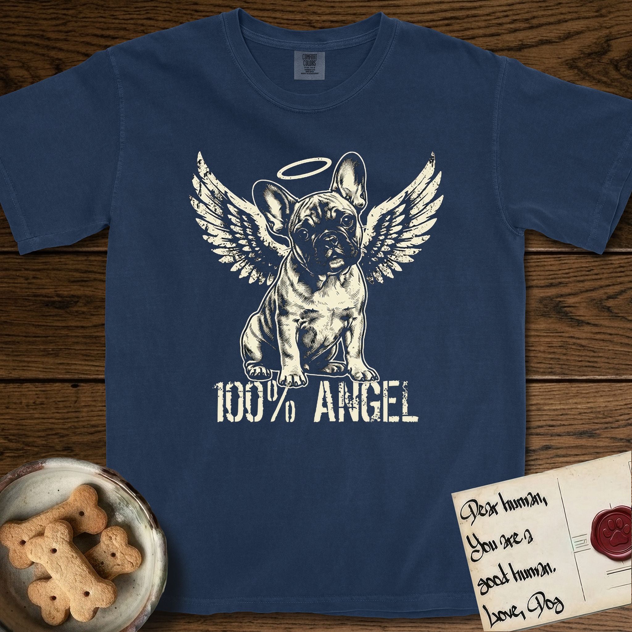 French Bulldog T-Shirt flat lay in True Navy, featuring Distressed cream one-color screen-print of a French Bulldog puppy as an angel, head cocked to one side, wings spread and a halo above, with 100% ANGEL lettering across the bottom.