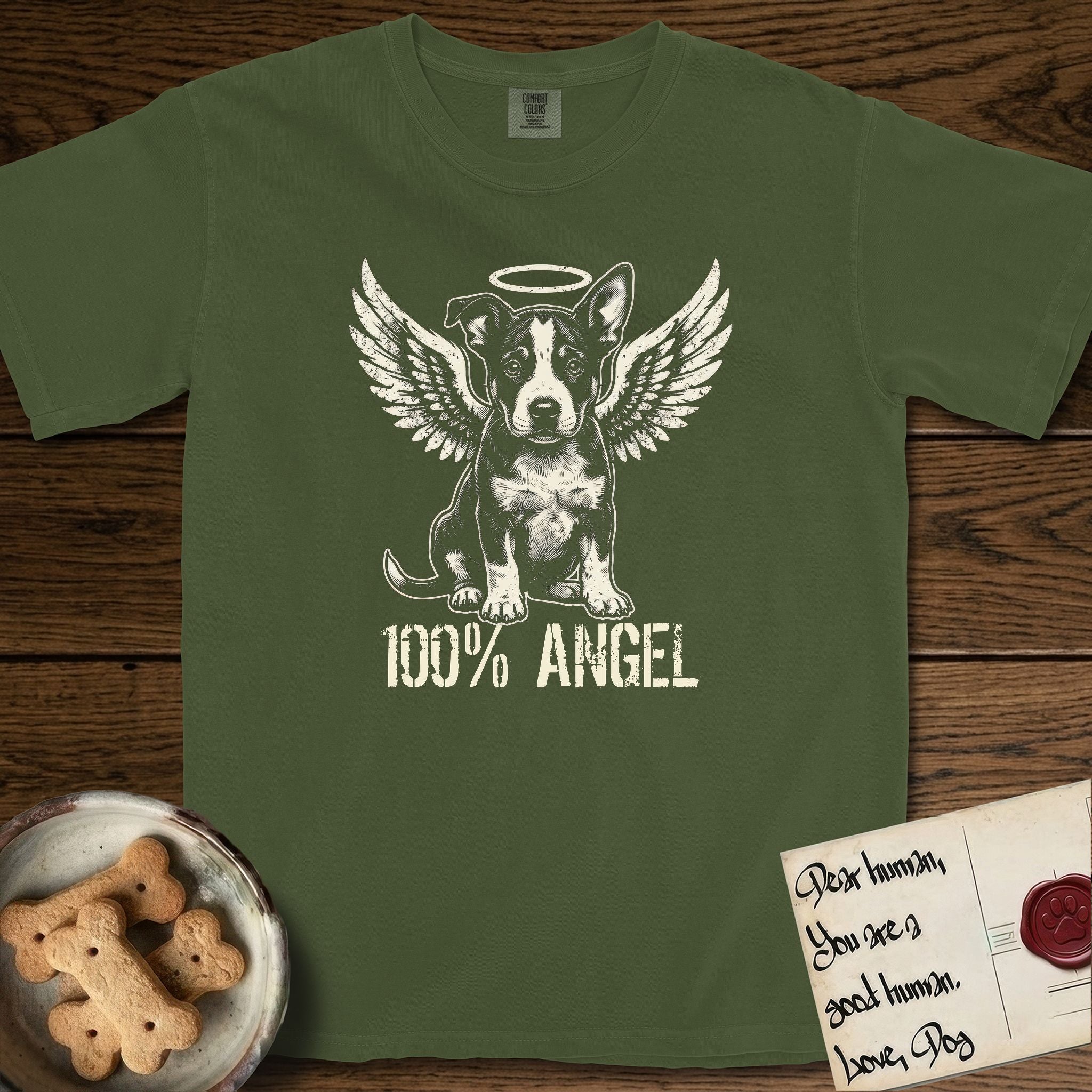 Lobo T-Shirt flat lay in Hemp, featuring Distressed cream one-color screen-print of a black-and-white Australian Cattle Dog and Pitbull mix puppy as an angel, big upright ears with one tip folded, wings spread and a halo above, with 100% ANGEL lettering across the bottom.