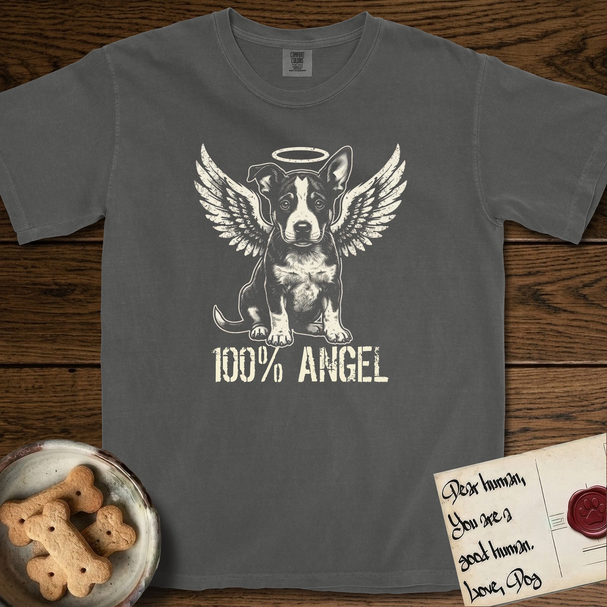 Lobo T-Shirt flat lay in Pepper, featuring Distressed cream one-color screen-print of a black-and-white Australian Cattle Dog and Pitbull mix puppy as an angel, big upright ears with one tip folded, wings spread and a halo above, with 100% ANGEL lettering across the bottom.