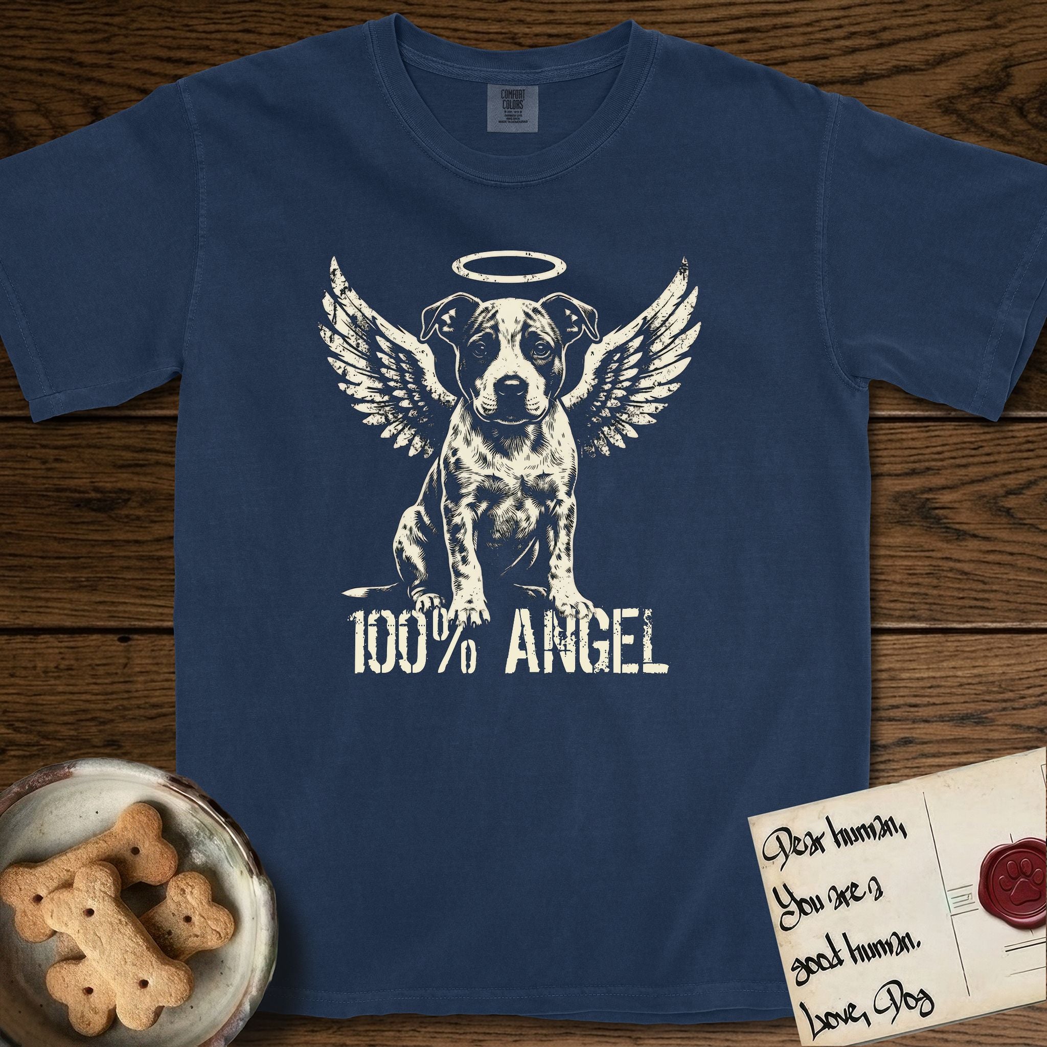 Pitbull T-Shirt flat lay in True Navy, featuring Distressed cream one-color screen-print of a Pitbull puppy as an angel, feathered wings spread and a halo above, sitting front-on, with 100% ANGEL lettering across the bottom.