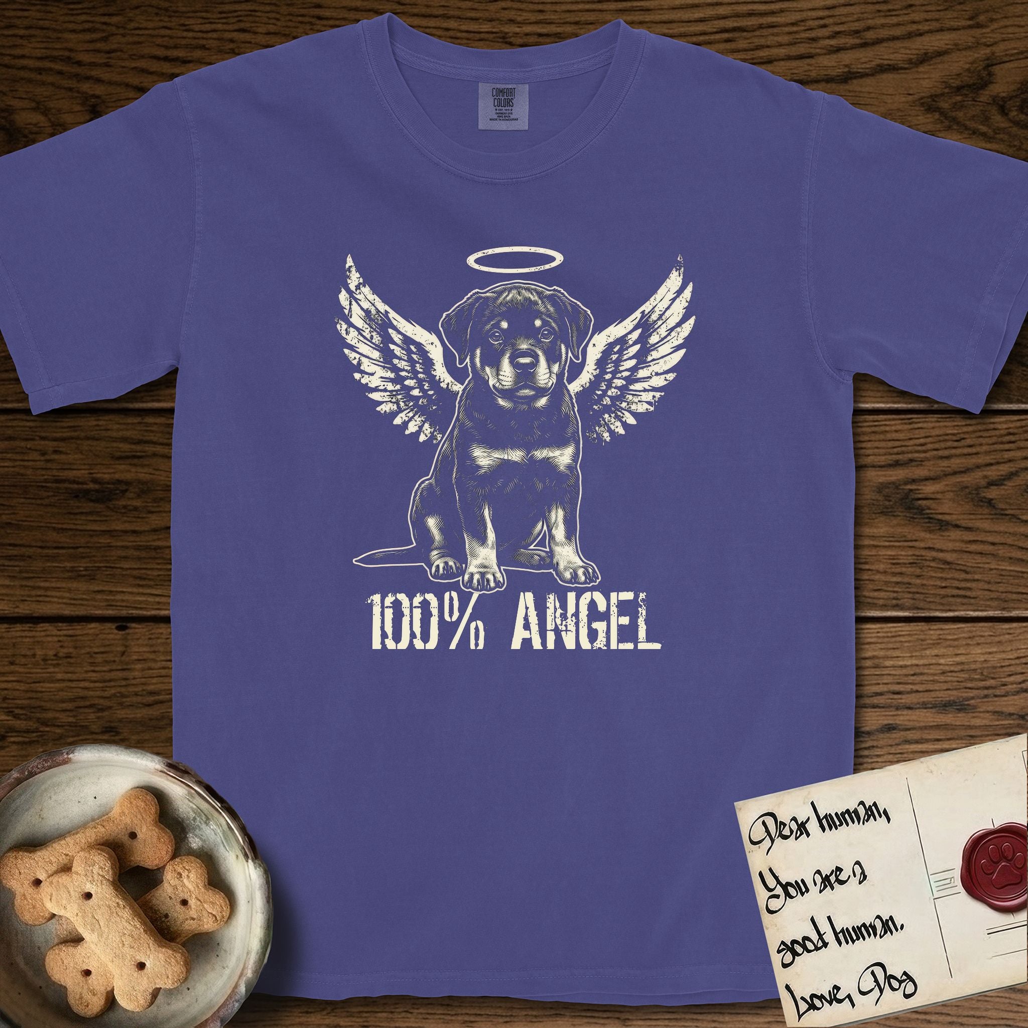 Rottweiler T-Shirt flat lay in Grape, featuring Distressed cream one-color screen-print of a Rottweiler puppy as an angel, sitting square and sturdy, wings spread and a halo above, with 100% ANGEL lettering across the bottom.