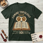 Canine Theology 101 T-Shirt flat lay in Forest Green, featuring a cream badge with an open book and two glowing paw prints rising above it, ringed by a circular halo.
