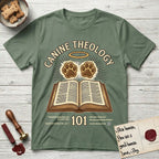 Canine Theology 101 T-Shirt flat lay in Military Green, featuring a cream badge with an open book and two glowing paw prints rising above it, ringed by a circular halo.