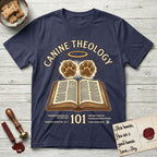 Canine Theology 101 T-Shirt flat lay in Navy, featuring a cream badge with an open book and two glowing paw prints rising above it, ringed by a circular halo.