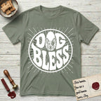 Dog Bless Australian Cattle Dog T-Shirt flat lay in Sage, featuring Retro bubble-letter badge reading DOG BLESS with a speckled Australian Cattle Dog face framed in the letter O, hand-drawn sunburst rays radiating outward.