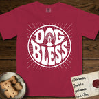 Dog Bless Basset Hound T-Shirt flat lay in Chili, featuring Retro bubble-letter badge reading DOG BLESS with a long-eared Basset Hound face framed in the letter O, hand-drawn sunburst rays radiating outward.