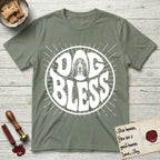 Dog Bless Basset Hound T-Shirt flat lay in Sage, featuring Retro bubble-letter badge reading DOG BLESS with a long-eared Basset Hound face framed in the letter O, hand-drawn sunburst rays radiating outward.
