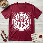 Dog Bless Beagle T-Shirt flat lay in Antique Cherry Red, featuring Retro bubble-letter badge reading DOG BLESS with a gentle Beagle face framed in the letter O, hand-drawn sunburst rays radiating outward.