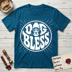 Dog Bless Beagle T-Shirt flat lay in Antique Sapphire, featuring Retro bubble-letter badge reading DOG BLESS with a gentle Beagle face framed in the letter O, hand-drawn sunburst rays radiating outward.