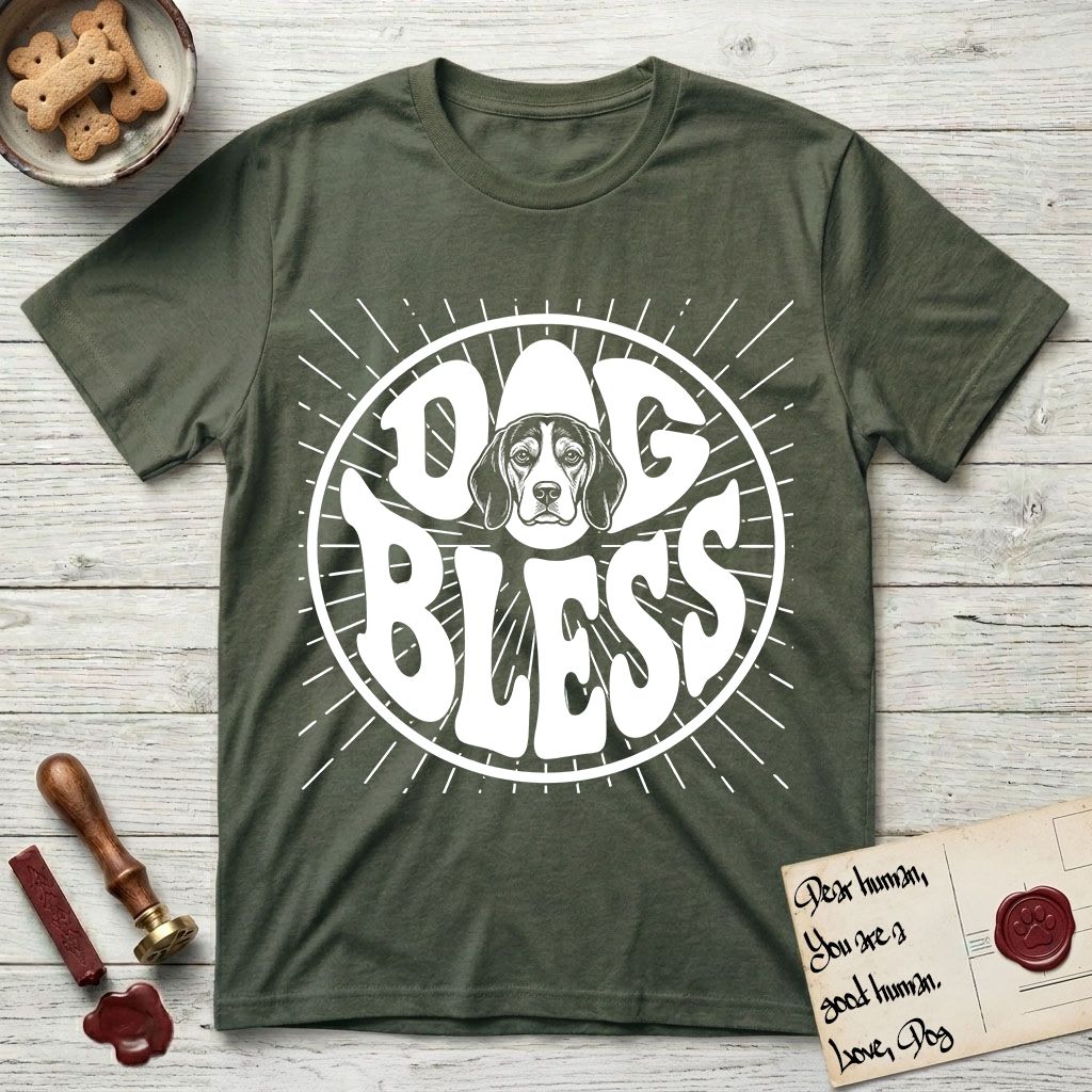 Dog Bless Beagle T-Shirt flat lay in Heather Military Green, featuring Retro bubble-letter badge reading DOG BLESS with a gentle Beagle face framed in the letter O, hand-drawn sunburst rays radiating outward.