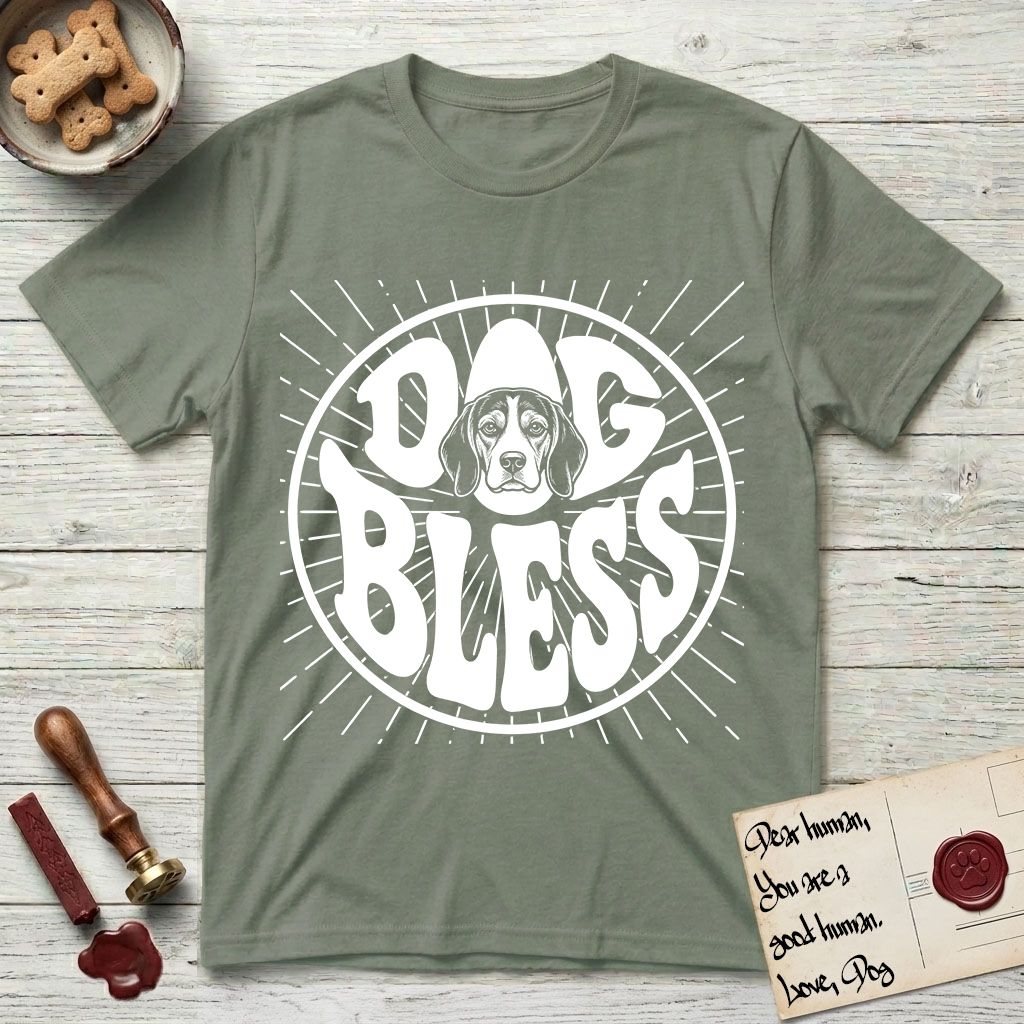 Dog Bless Beagle T-Shirt flat lay in Sage, featuring Retro bubble-letter badge reading DOG BLESS with a gentle Beagle face framed in the letter O, hand-drawn sunburst rays radiating outward.
