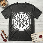 Dog Bless Chihuahua T-Shirt flat lay in Charcoal, featuring Retro bubble-letter badge reading DOG BLESS with a wide-eyed Chihuahua face framed in the letter O, oversized ears reaching past the letter, hand-drawn sunburst rays radiating outward.