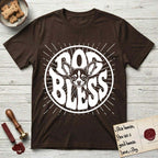 Dog Bless Chihuahua T-Shirt flat lay in Dark Chocolate, featuring Retro bubble-letter badge reading DOG BLESS with a wide-eyed Chihuahua face framed in the letter O, oversized ears reaching past the letter, hand-drawn sunburst rays radiating outward.