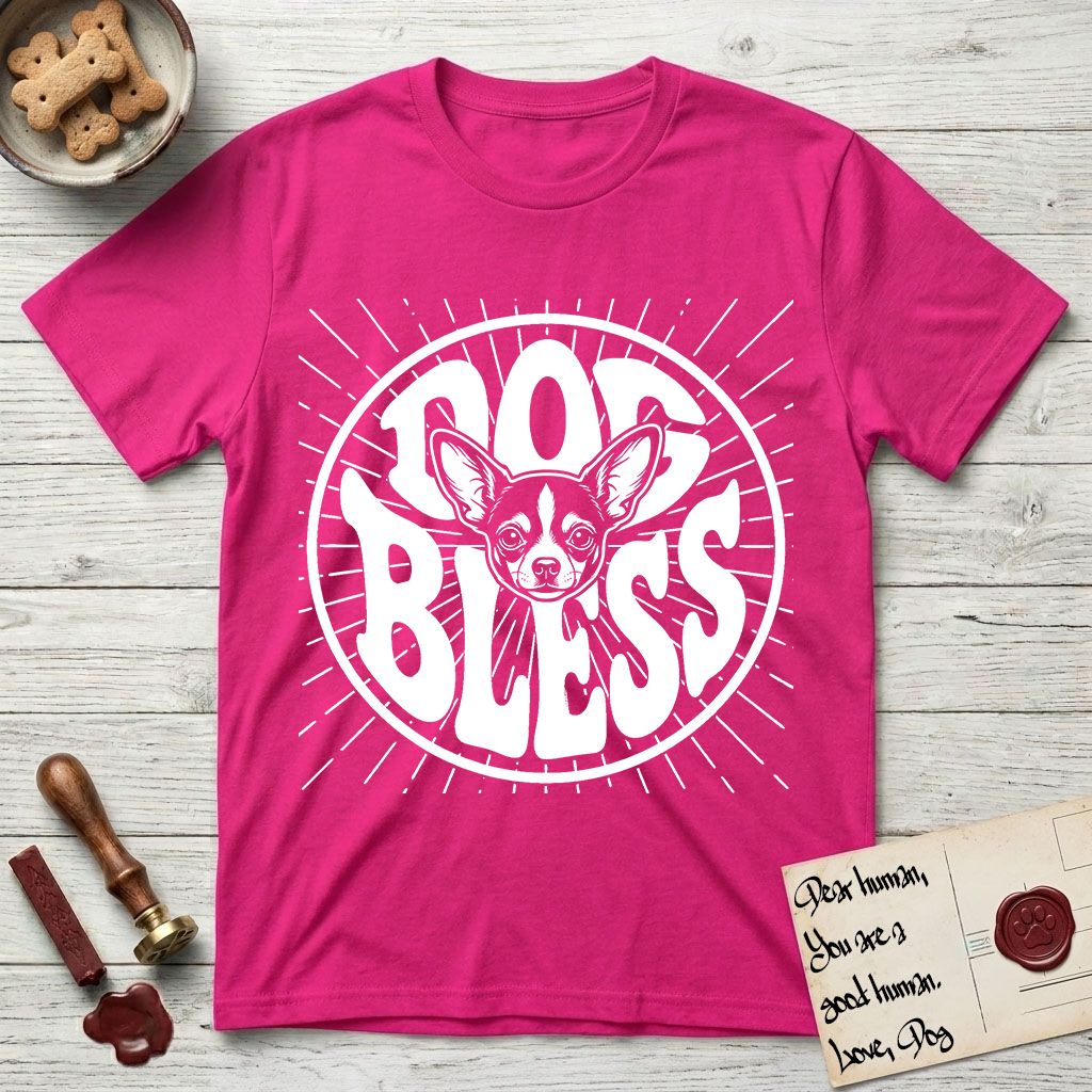 Dog Bless Chihuahua T-Shirt flat lay in Heliconia, featuring Retro bubble-letter badge reading DOG BLESS with a wide-eyed Chihuahua face framed in the letter O, oversized ears reaching past the letter, hand-drawn sunburst rays radiating outward.