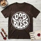 Dog Bless Corgi T-Shirt flat lay in Dark Chocolate, featuring Retro bubble-letter badge reading DOG BLESS with a smiling Corgi face framed in the letter O, chest fluff spilling below the letter, hand-drawn sunburst rays radiating outward.