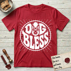 Dog Bless German Shepherd T-Shirt flat lay in Cherry Red, featuring Retro bubble-letter badge reading DOG BLESS with a German Shepherd face with tall upright ears framed in the letter O, hand-drawn sunburst rays radiating outward.