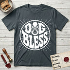 Dog Bless German Shepherd T-Shirt flat lay in Dark Heather Grey, featuring Retro bubble-letter badge reading DOG BLESS with a German Shepherd face with tall upright ears framed in the letter O, hand-drawn sunburst rays radiating outward.