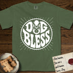 Dog Bless German Shepherd T-Shirt flat lay in Moss, featuring Retro bubble-letter badge reading DOG BLESS with a German Shepherd face with tall upright ears framed in the letter O, hand-drawn sunburst rays radiating outward.