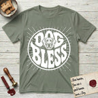 Dog Bless Great Dane T-Shirt flat lay in Sage, featuring Retro bubble-letter badge reading DOG BLESS with a gentle Great Dane face with natural floppy ears framed in the letter O, hand-drawn sunburst rays radiating outward.