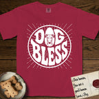 Dog Bless Greyhound T-Shirt flat lay in Chili, featuring Retro bubble-letter badge reading DOG BLESS with a slender Greyhound face with folded rose ears framed in the letter O, hand-drawn sunburst rays radiating outward.