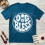 Dog Bless Husky T-Shirt flat lay in Antique Sapphire, featuring Retro bubble-letter badge reading DOG BLESS with a masked Husky face framed in the letter O, hand-drawn sunburst rays radiating outward.