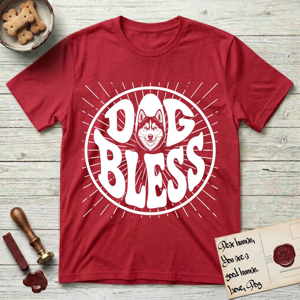 Dog Bless Husky T-Shirt flat lay in Cherry Red, featuring Retro bubble-letter badge reading DOG BLESS with a masked Husky face framed in the letter O, hand-drawn sunburst rays radiating outward.