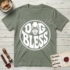 Dog Bless Husky T-Shirt flat lay in Sage, featuring Retro bubble-letter badge reading DOG BLESS with a masked Husky face framed in the letter O, hand-drawn sunburst rays radiating outward.